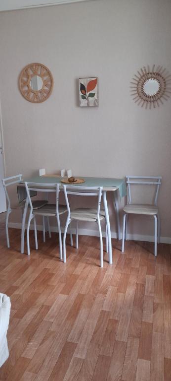 a dining room with a table and two chairs at Appartement Bagnères-de-Luchon T2 nuitée-semaines in Luchon