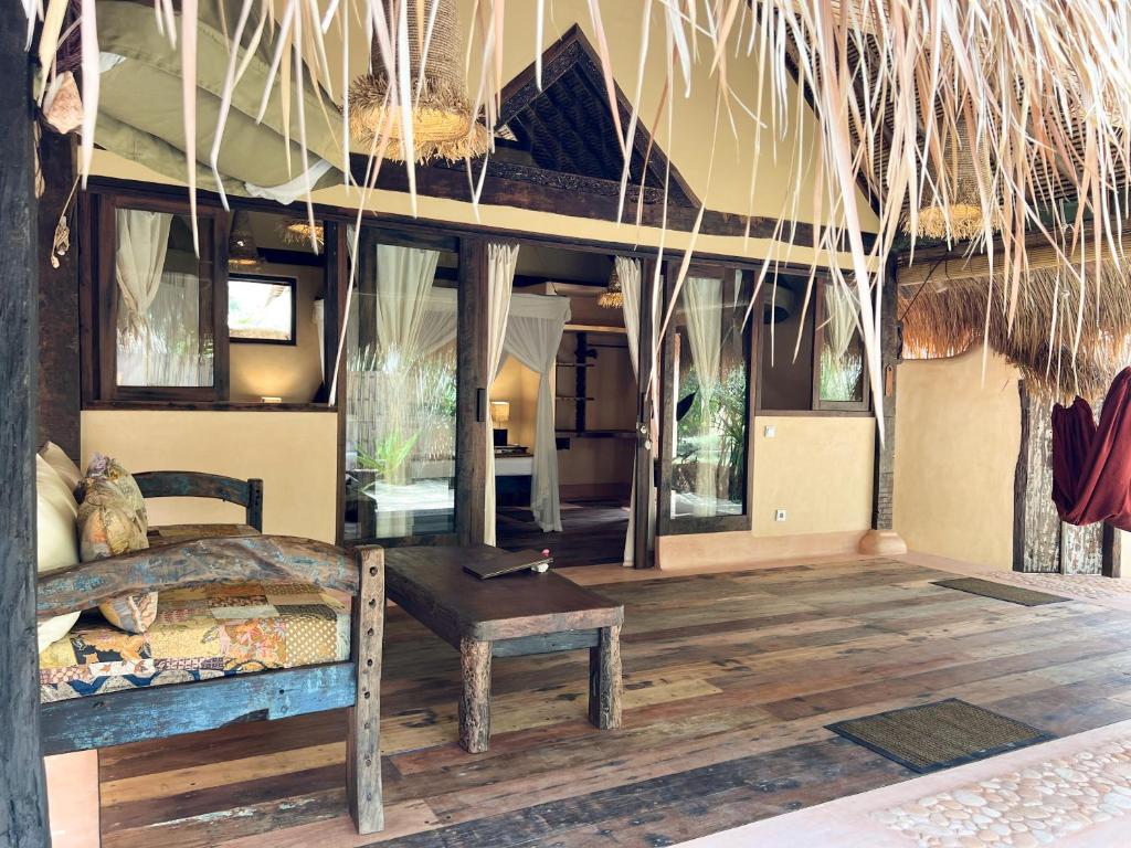 a bedroom with a bed and a table in a room at Gili Asahan Eco Lodge & Restaurant in Gili Asahan