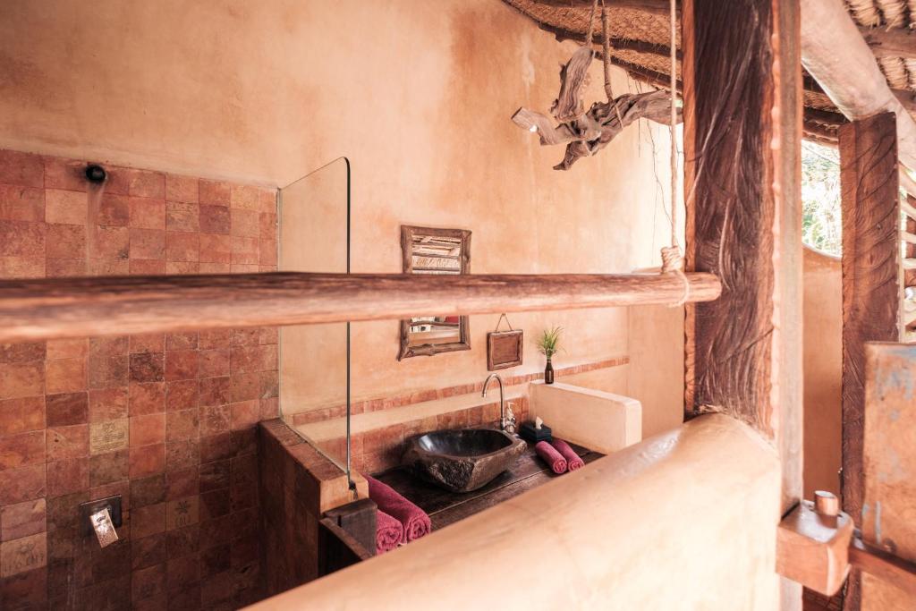a bathroom with a sink in a room at Gili Asahan Eco Lodge & Restaurant in Gili Asahan