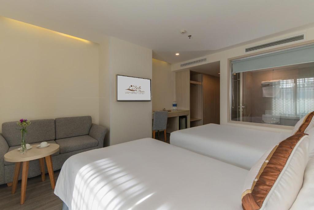 Giường trong phòng chung tại Stella Maris Nha Trang Hotel