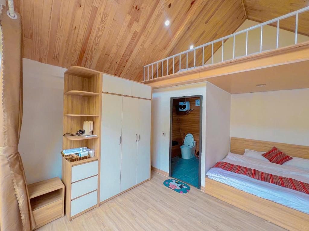a small bedroom with a bunk bed and a staircase at Linh Anh Homestay MC - by BAY LUXURY in Mộc Châu