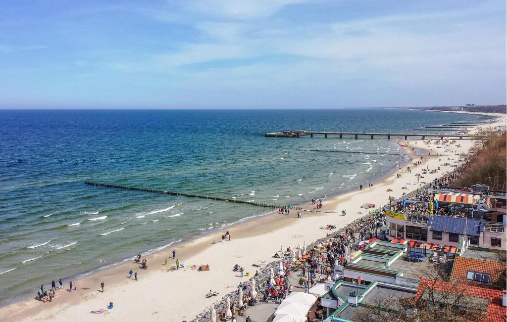 a view of a beach with people and the ocean at 1 Bedroom Cozy Home In Kolobrzeg in Kołobrzeg