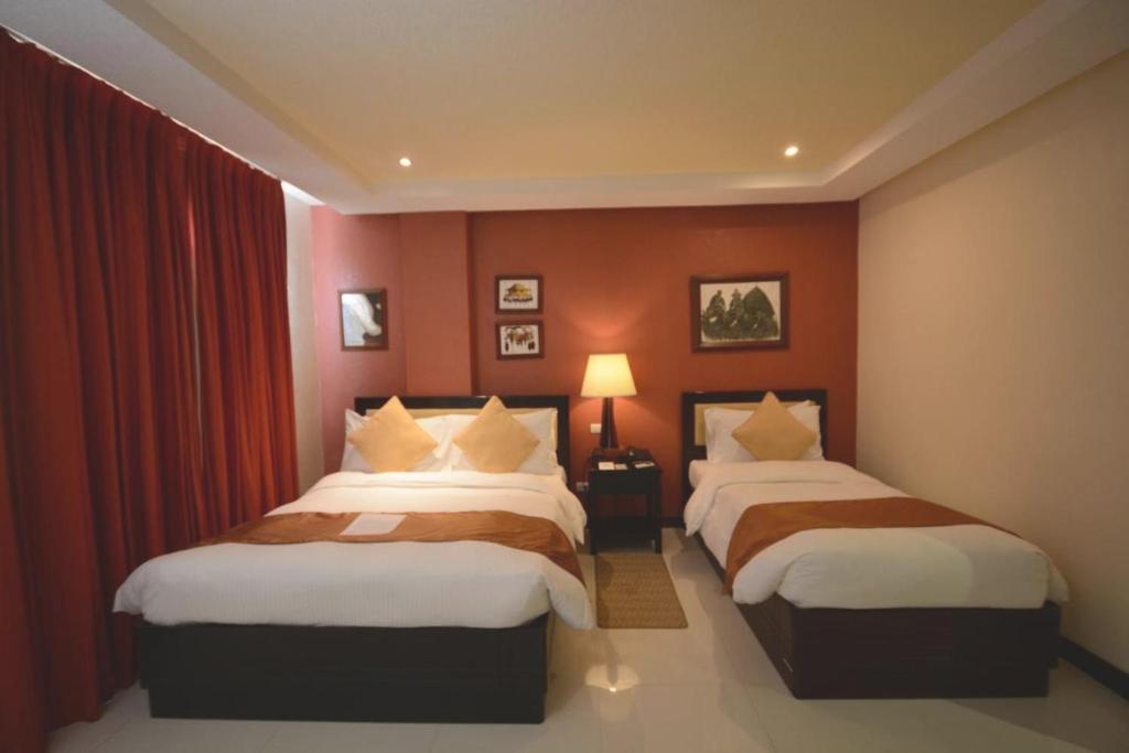 Postel nebo postele na pokoji v ubytování Hotel Centro Puerto Princesa Near Airport