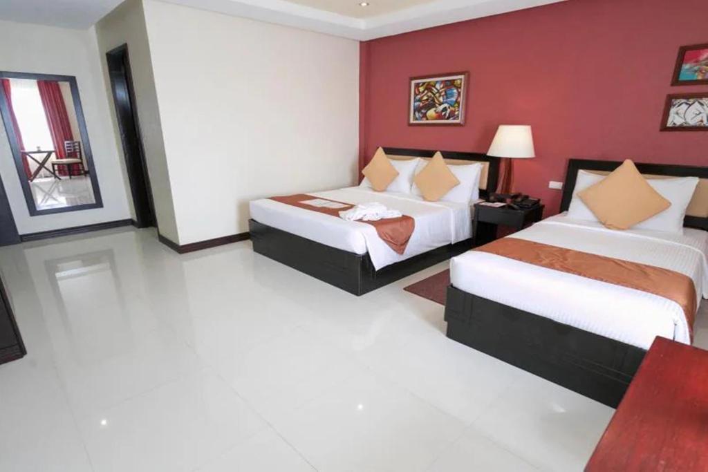 Postel nebo postele na pokoji v ubytování Hotel Centro Puerto Princesa Near Airport