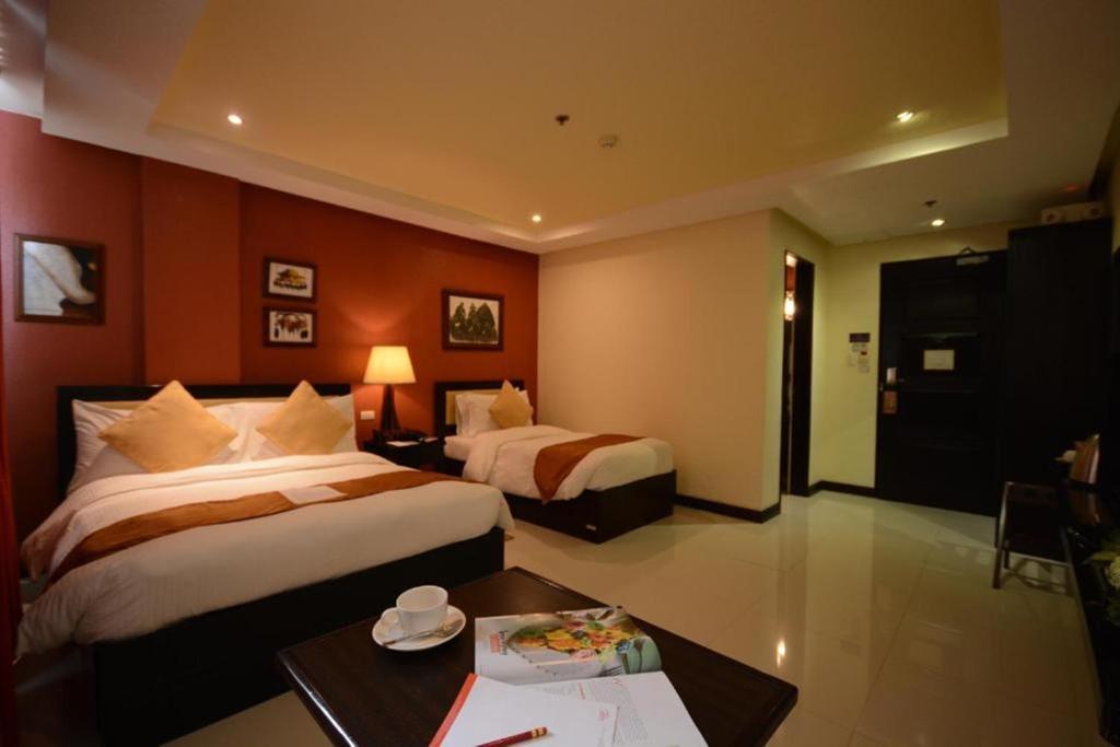 Postel nebo postele na pokoji v ubytování Hotel Centro Puerto Princesa Near Airport