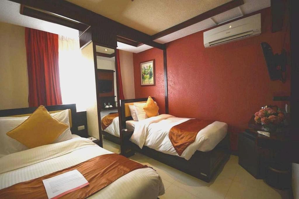 Postel nebo postele na pokoji v ubytování Hotel Centro Puerto Princesa Near Airport
