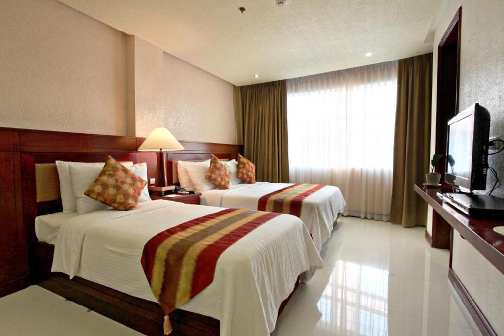 Postel nebo postele na pokoji v ubytování Hotel Centro Puerto Princesa Near Airport