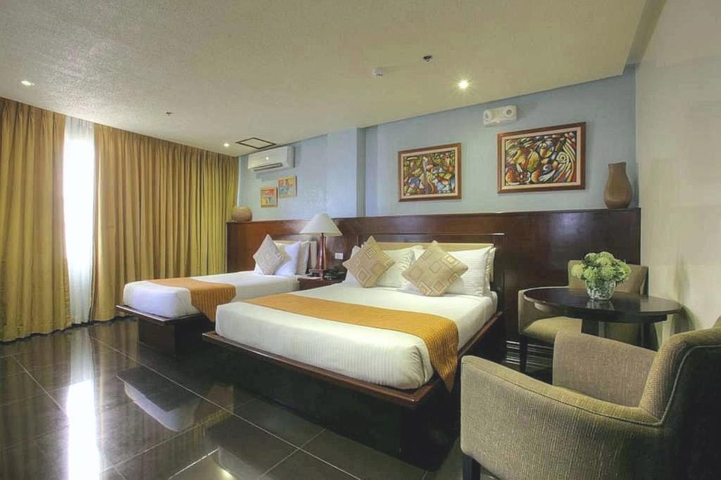 Postel nebo postele na pokoji v ubytování Hotel Centro Puerto Princesa Near Airport