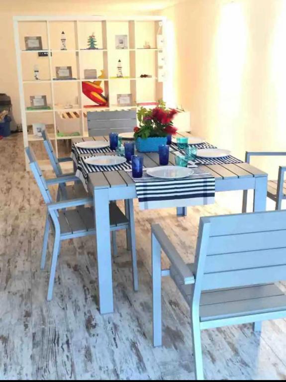 a blue table and chairs in a room at Nido dell'Argentario - Porto Santo Stefano in Porto Santo Stefano