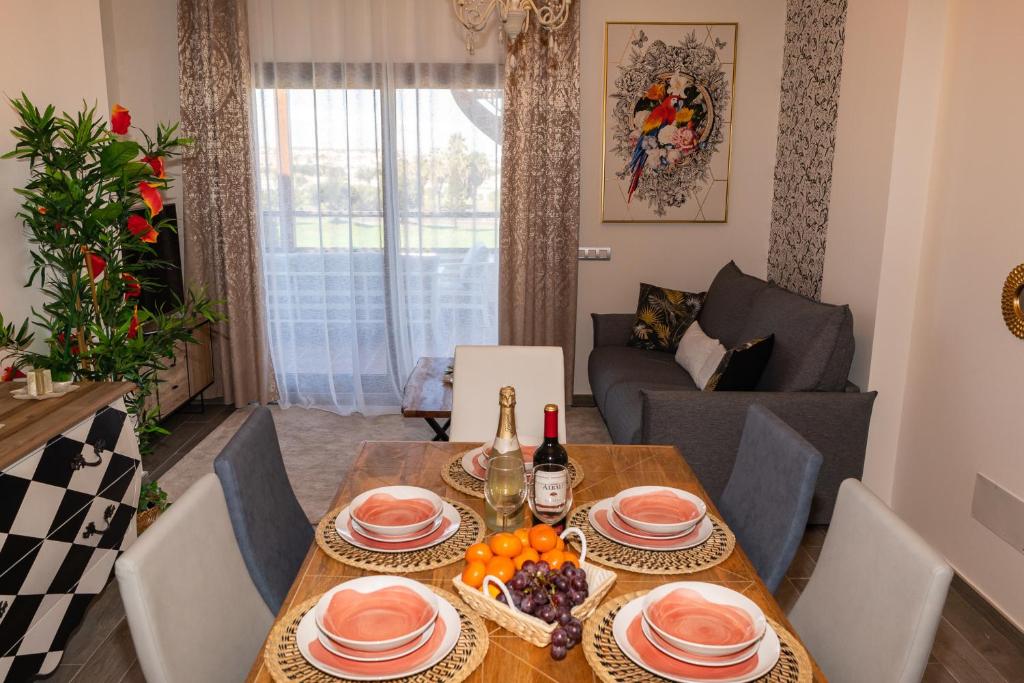 a dining room with a table and a couch at Casa Paraiso in Caleta De Fuste