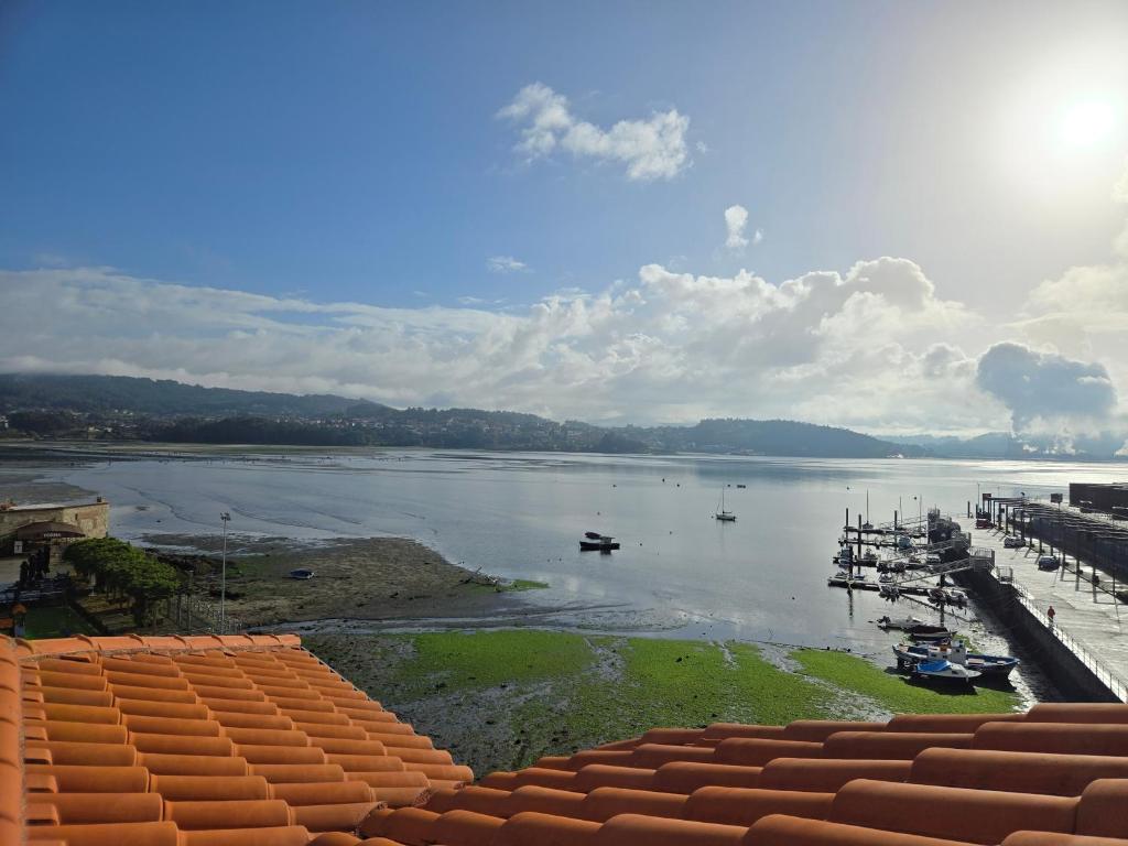 a view of a river with boats in the water at Ático Pequeño Paraíso Combarro in Combarro