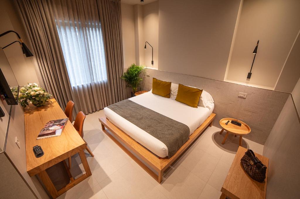 Postel nebo postele na pokoji v ubytování Hotel Leopardi