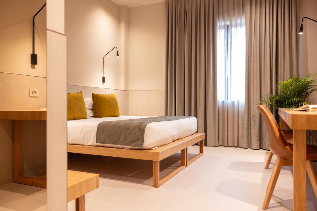 Postel nebo postele na pokoji v ubytování Hotel Leopardi
