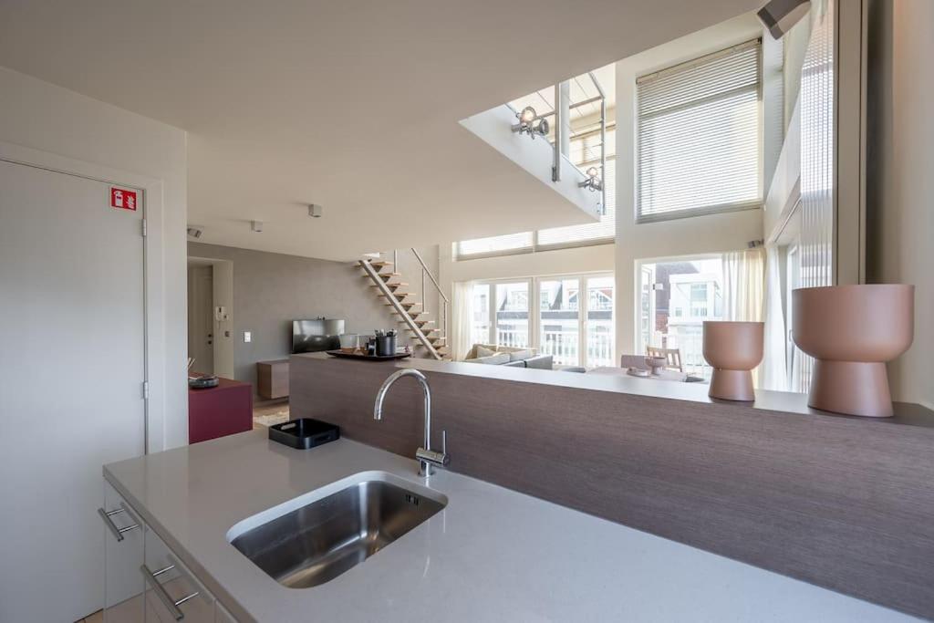 a kitchen with a sink and a counter top at Sir William, duplex appartement Knokke in Knokke-Heist