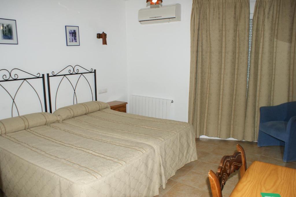 Postel nebo postele na pokoji v ubytování Hotel Juan Francisco