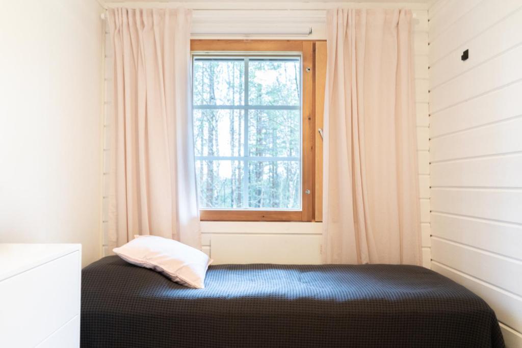 Postel nebo postele na pokoji v ubytování Hotel Ylläsrinne