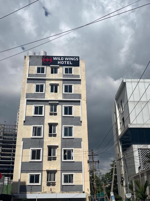 a building with a sign on the side of it at Wildwings hotel in Hyderabad