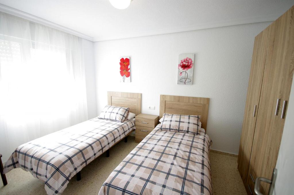 Postel nebo postele na pokoji v ubytování Livingtarifa Casa Del Mar
