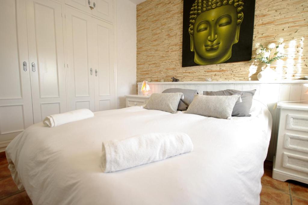 a white bed with two pillows on top of it at Livingtarifa Chalet La Caracola in Tarifa