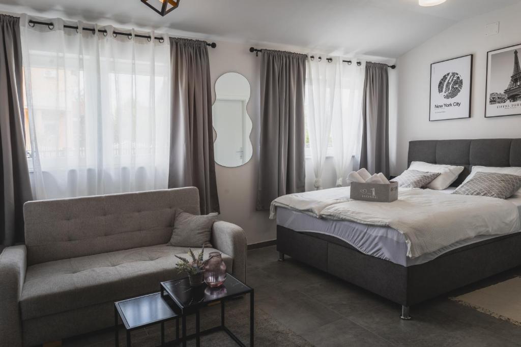 a bedroom with a bed and a couch at Studio apartman Mare in Velika Gorica