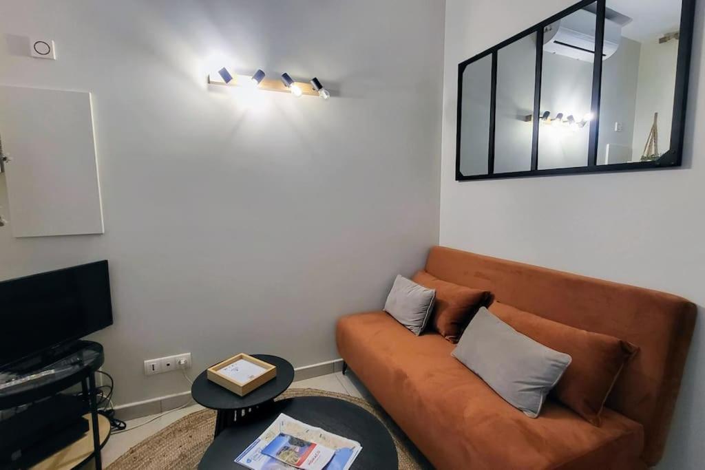 un salon avec un canapé et un miroir dans l'établissement Patio d'Azur- Coquet Studio 2pers 2lits Proche Plages, à Nice