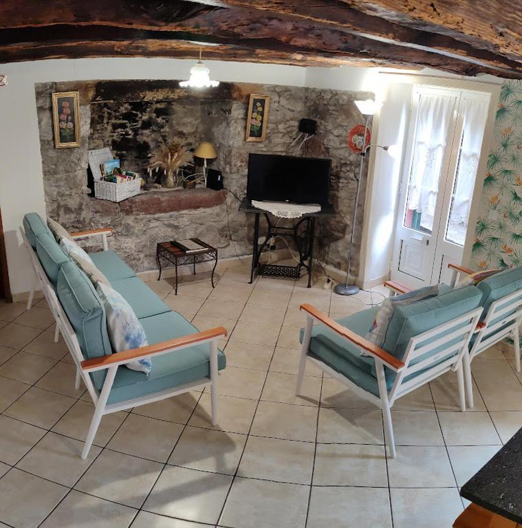 a living room with two chairs and a table at Casa da Guida in Paul do Mar