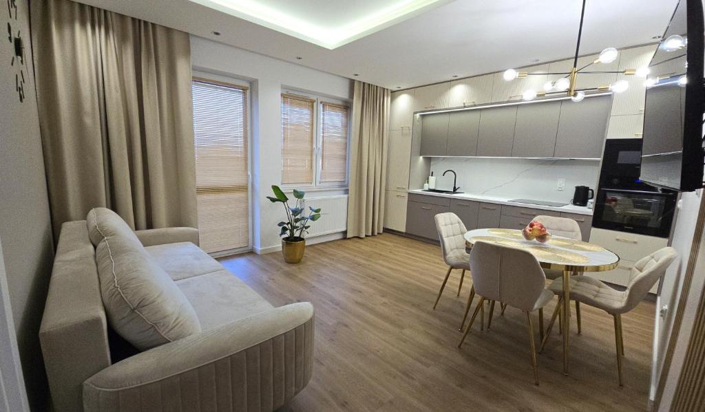 a living room with a couch and a table at Apartament Gimnazjalna Luxury in Końskie