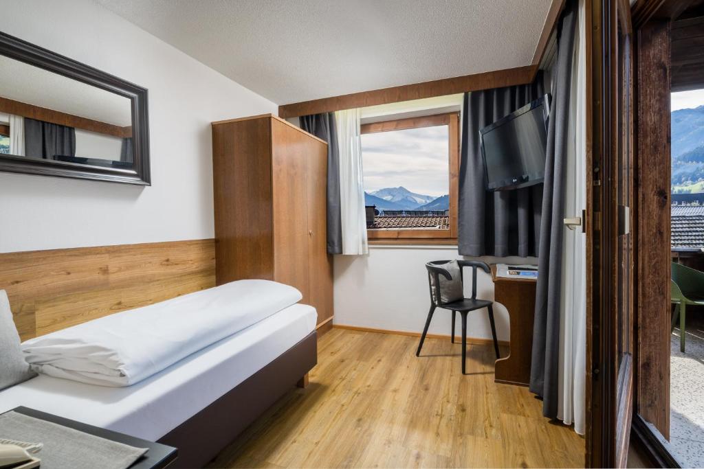 Postel nebo postele na pokoji v ubytování Hotel Standlhof Zillertal