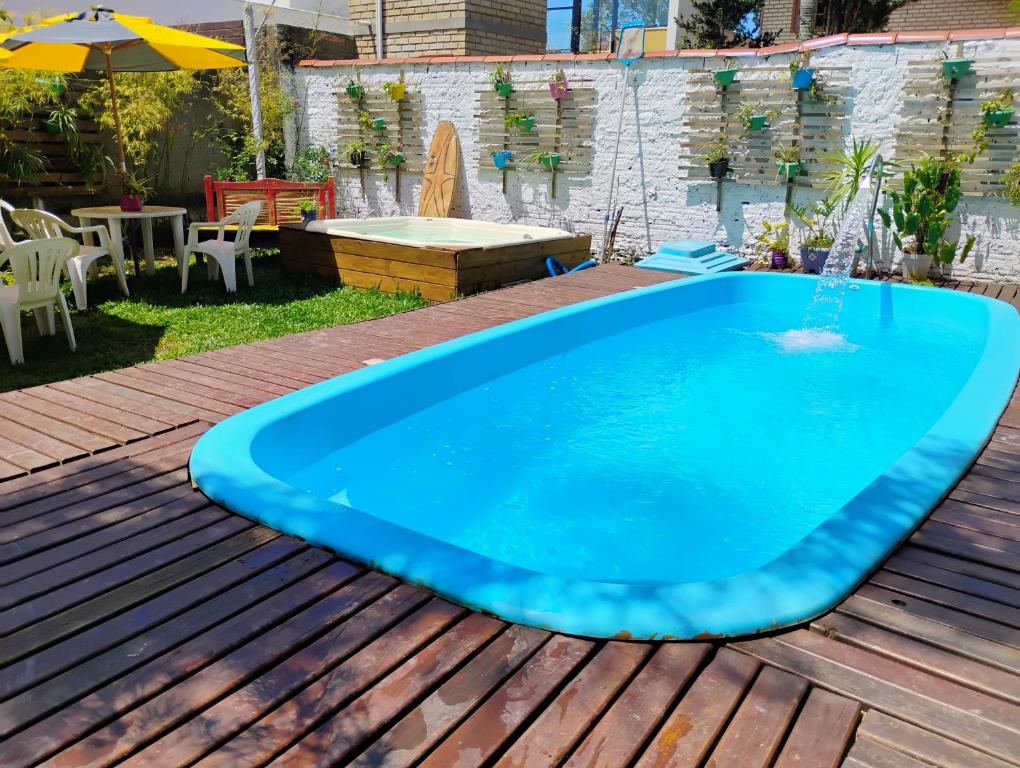 a swimming pool on a deck with a hot tub at Pousada Beach Eco House Floripa Com Ar Condicionado in Florianópolis