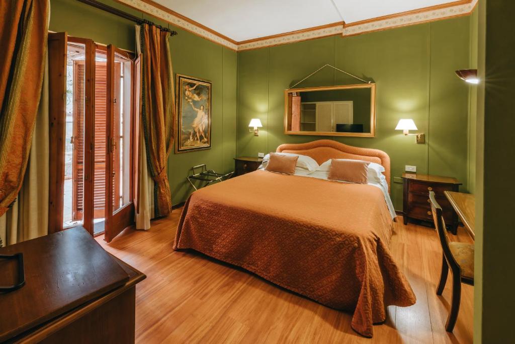 Postel nebo postele na pokoji v ubytování Hotel Bramante