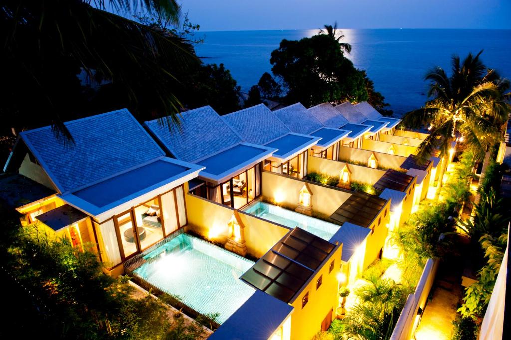 an aerial view of a villa with a swimming pool at night at Pawanthorn Samui - SHA Plus in Chaweng