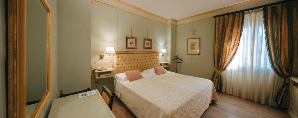 Postel nebo postele na pokoji v ubytování Hotel Bramante