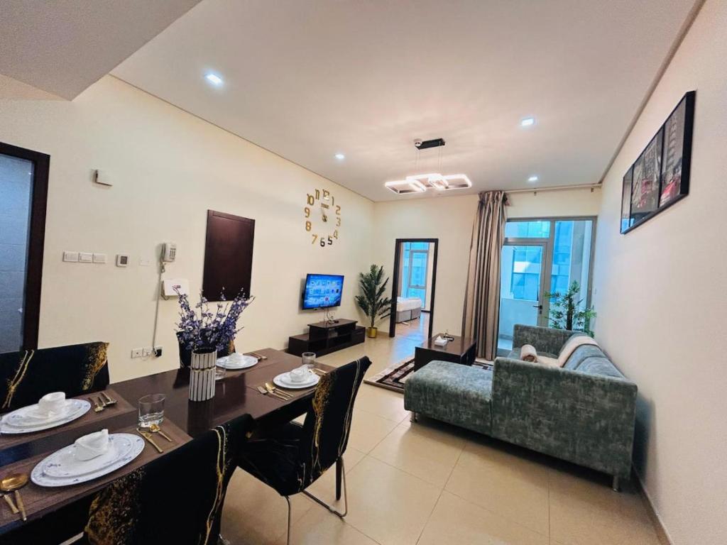 a living room with a table and a couch at Aspire Tower - One Bedroom Solo Haven Juffair in Manama