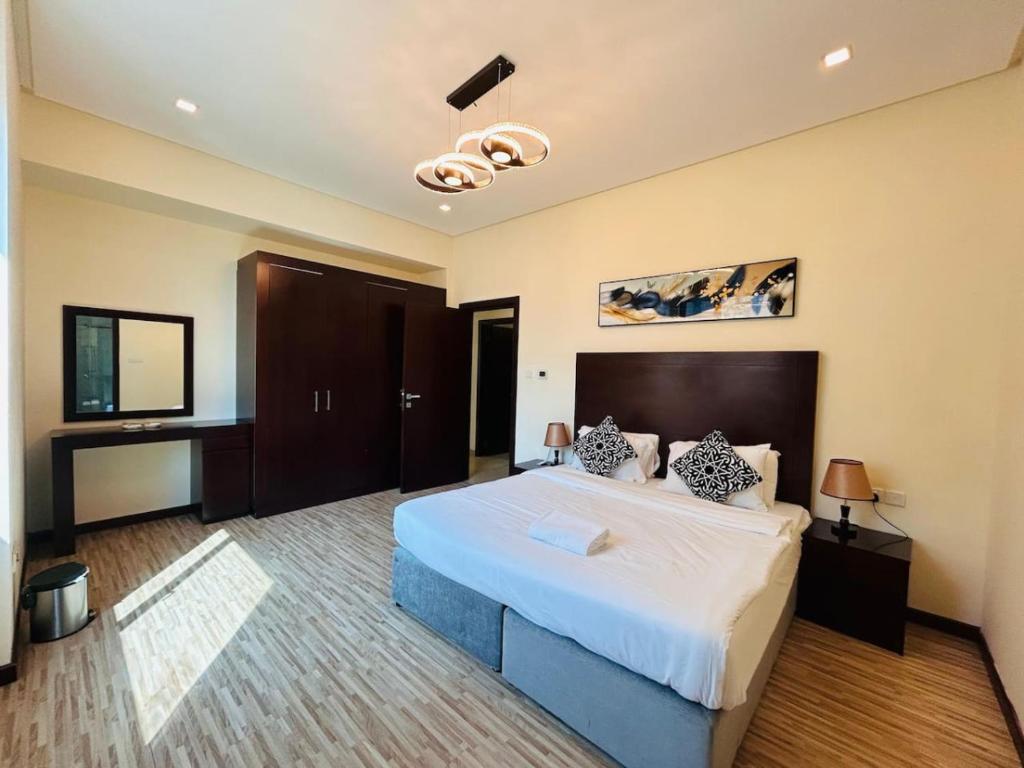 a bedroom with a large bed in a room at Aspire Tower-Two Bedroom Urban Haven Juffair in Manama