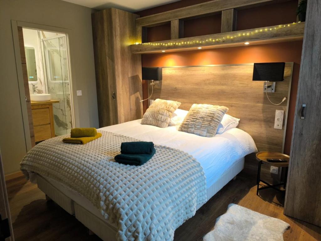a bedroom with a bed with two pillows on it at 2 Pièces Cozy Place Morny refait à neuf in Deauville