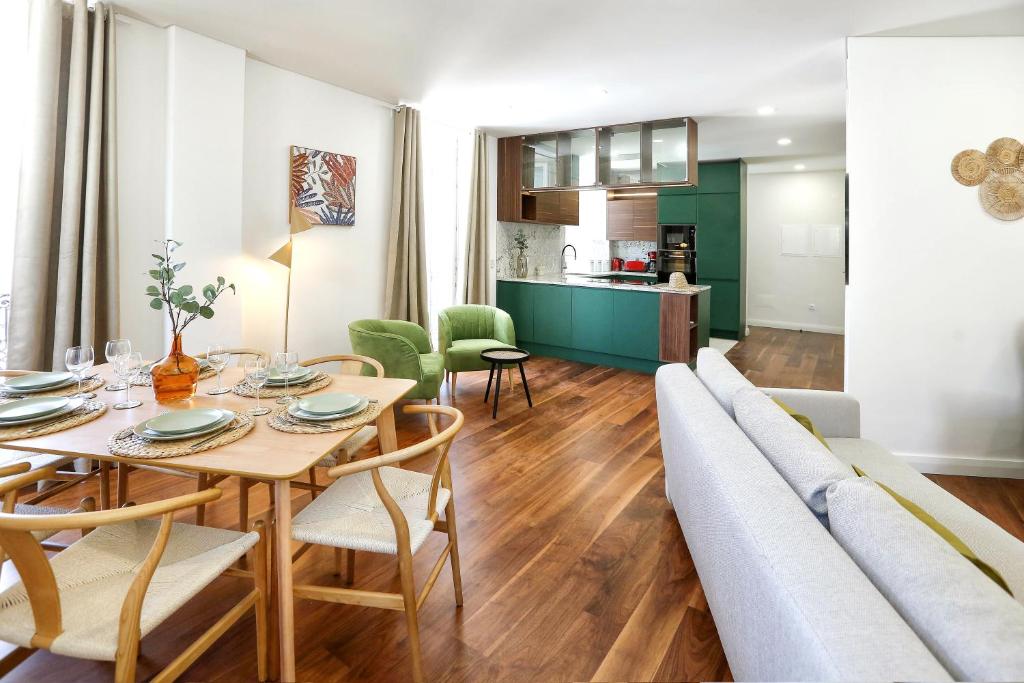 a living room with a table and a couch at Green Essence Duplex in Faro by Misha's Place in Faro