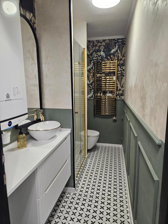 a bathroom with a sink and a toilet in it at Luxusný apartmán pri nemocnici in Košice