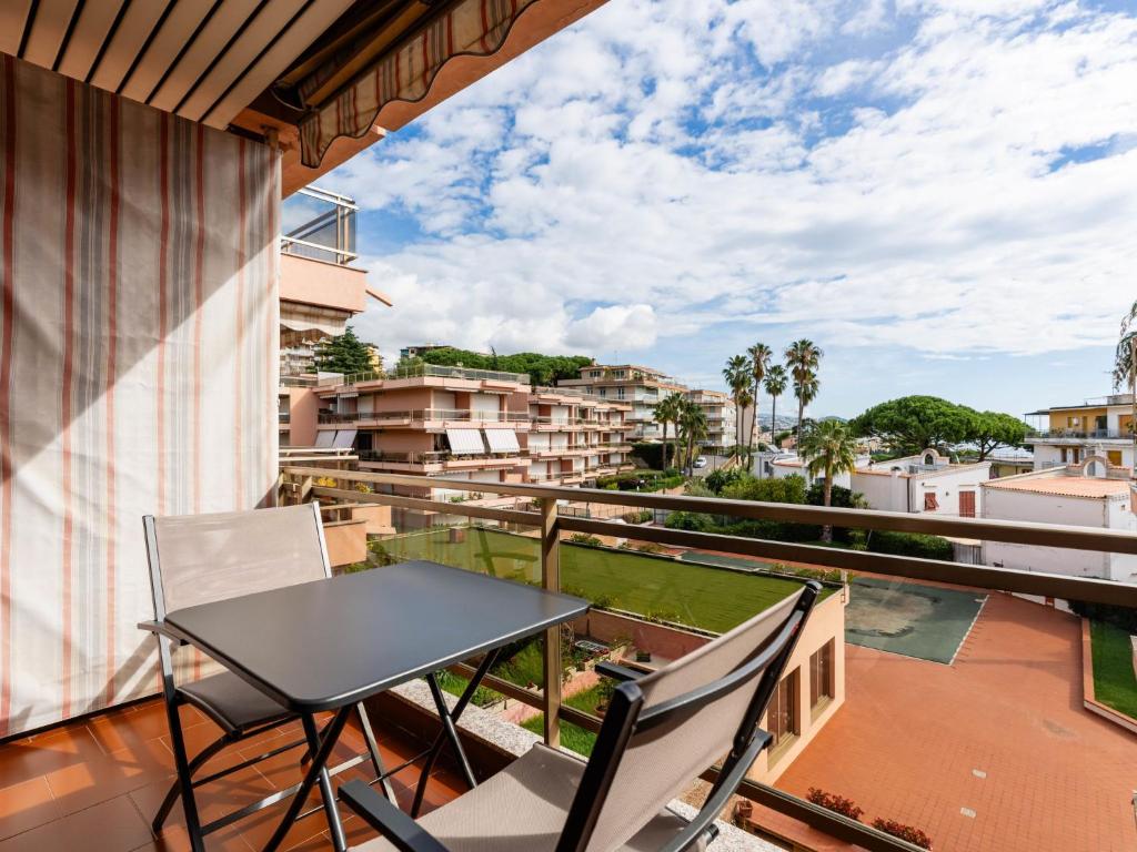 a table and chairs on a balcony with a view at Apartment AcquadiMare by Interhome in Sanremo