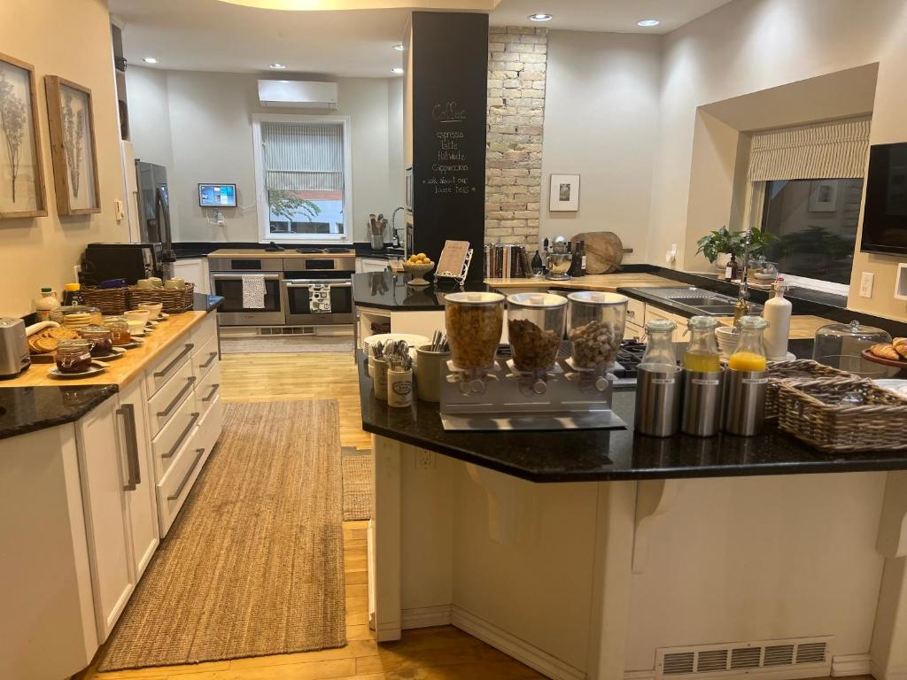 a large kitchen with a counter with food on it at No. 5 East in Winnipeg