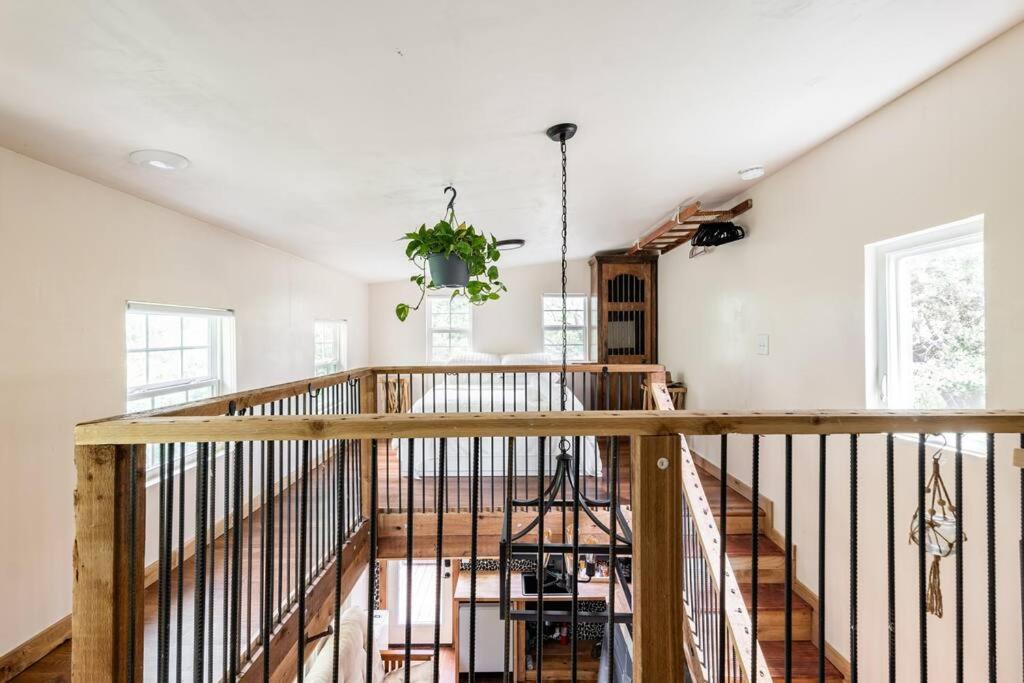 a room with a wooden staircase with a potted plant at Cozy Coop Casita - Lake Travis-Hot Tub-Tiny House in Austin