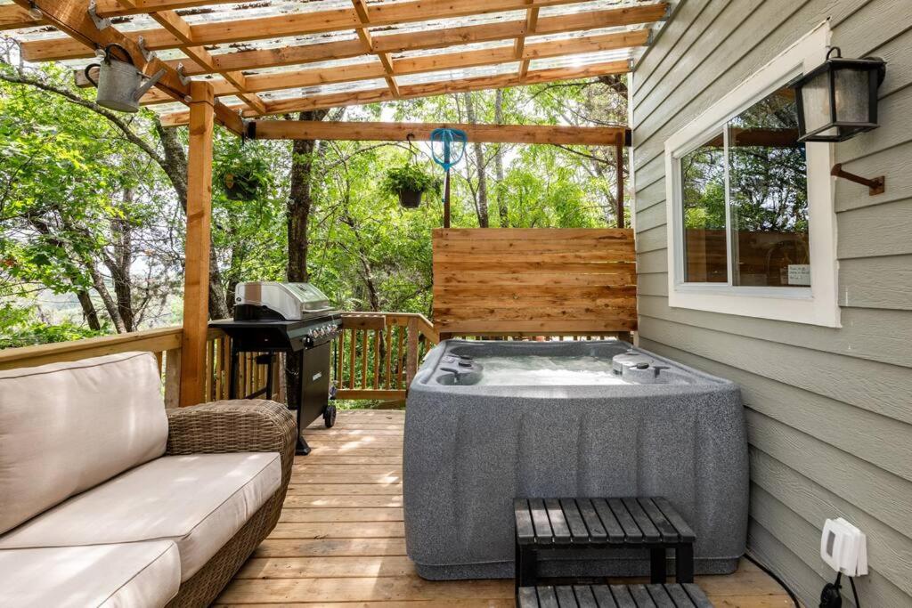 a patio with a hot tub and a grill at Cozy Coop Casita - Lake Travis-Hot Tub-Tiny House in Austin