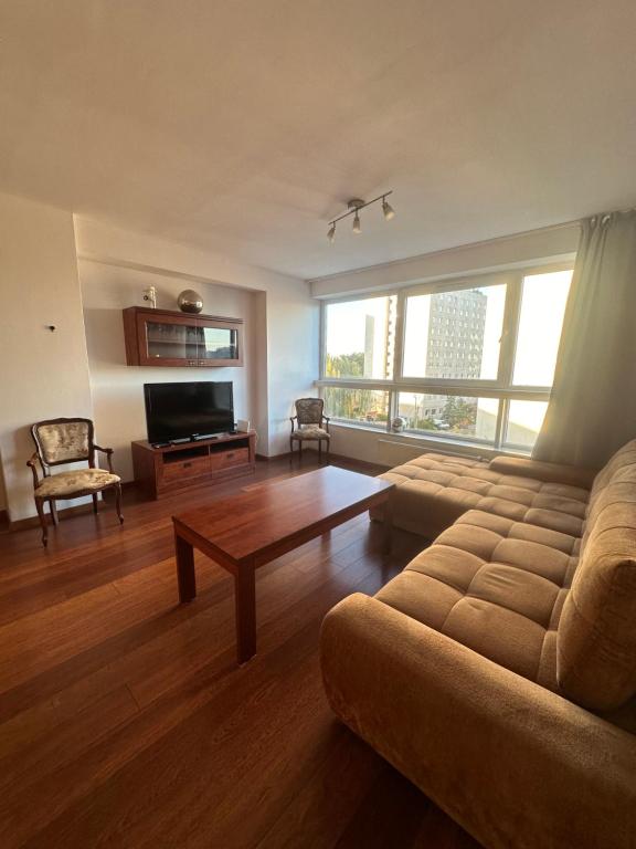 a living room with a couch and a coffee table at Private Apartment Poznań - Free Parking - Netflix in Poznań
