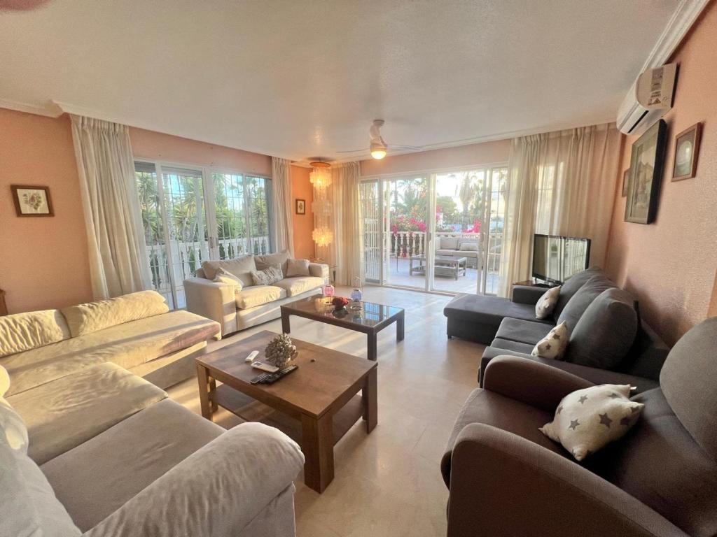 a living room with couches and a coffee table at Sergio Village, a 200mt del Mar! in Isla Plana