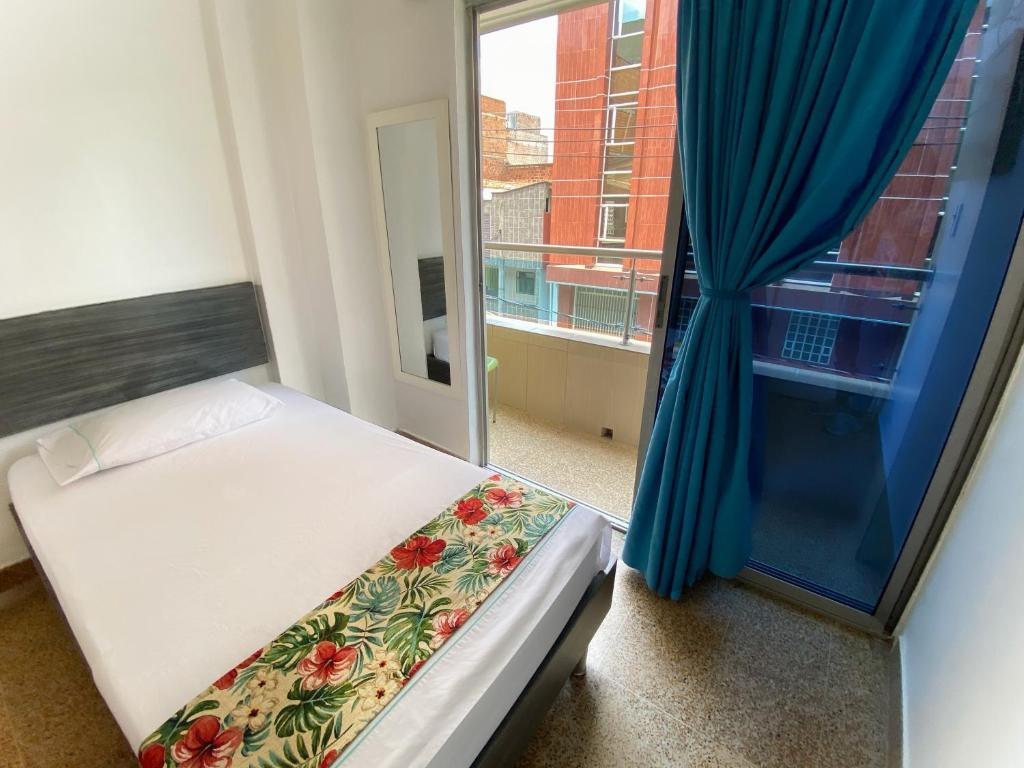 Postel nebo postele na pokoji v ubytování Hotel Plaza Mayor Itagui