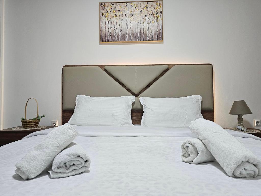 a bedroom with a white bed with towels on it at Superb 1 bedroom in the best zone of the city. in Ferizaj