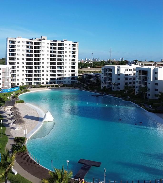 a large swimming pool next to a beach with buildings at Blue Mazatlán in Mazatlán