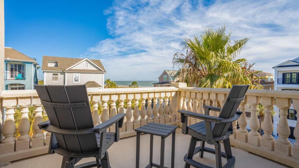 two chairs sitting on a balcony overlooking the ocean at Luxury 7BR w Ocean Views & Private Pool in Hilton Head Island