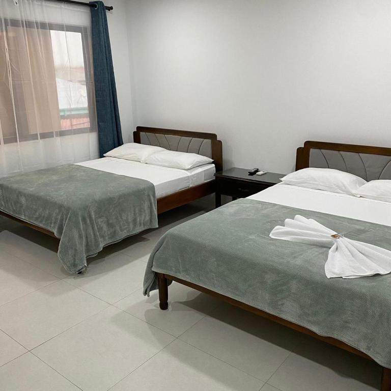 Postel nebo postele na pokoji v ubytování Hotel Naralit