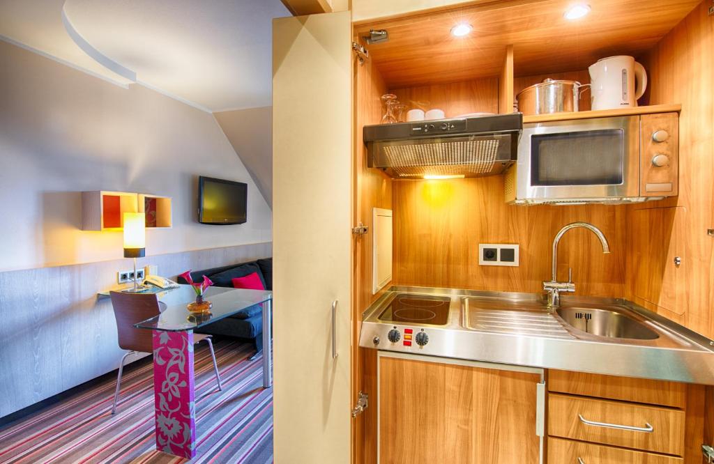 Kuchyň nebo kuchyňský kout v ubytování Leonardo Hotel & Residenz Muenchen