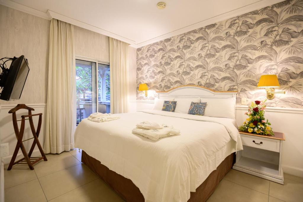 Postel nebo postele na pokoji v ubytování Hotel Villa Morra Suites